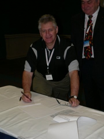 Kevin Colley signing the MOU between the ETA and EWRB on behalf of ETA
