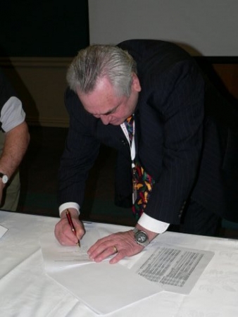 Murray Willis signing the MOU between the ETA and EWRB on behalf of EWRB