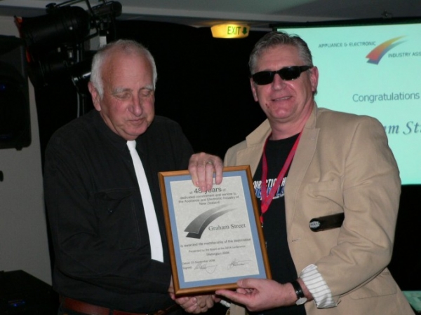 Graham Street receiving life membership from Kevin Colley, President AEIA